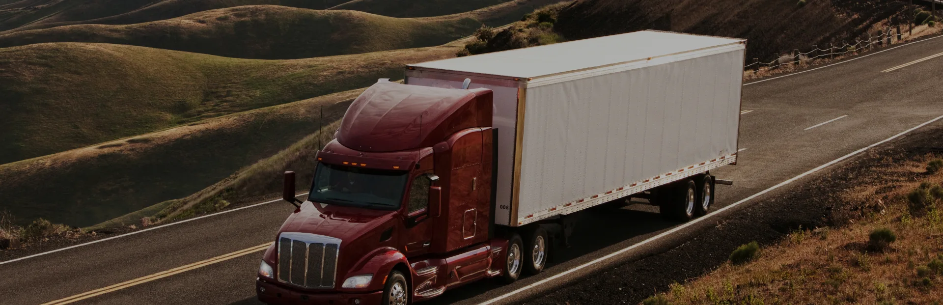TOP Worldwide expedited freight services with a semi truck speeding down the highway for time-critical deliveries.