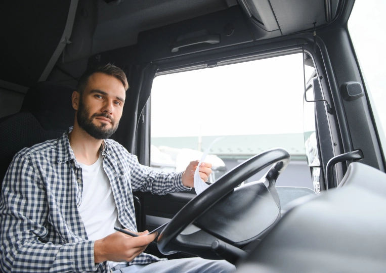 Professional truck driver at the wheel of a semi truck representing reliable carrier partnerships with TOP Worldwide.