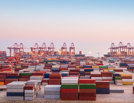 TOP Worldwide ocean freight with shipping containers sitting at a port, illustrating efficient import and export logistics.