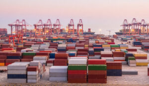 TOP Worldwide ocean freight with shipping containers sitting at a port, illustrating efficient import and export logistics.