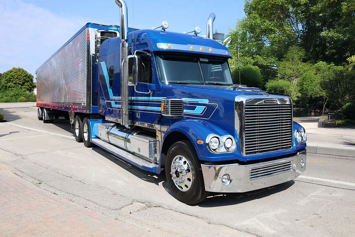 LTL TOP Worldwide semi truck on the highway, representing the transportation backbone of LTL pricing and freight cost strategies.