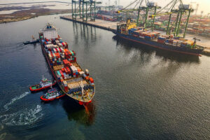 TOP Worldwide ocean freight vessel with stacked shipping containers, offering tailored solutions for small businesses.