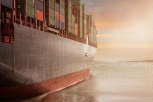 TOP Worldwide ocean freight vessel with stacked shipping containers, showcasing efficient global logistics and containerized cargo solutions.