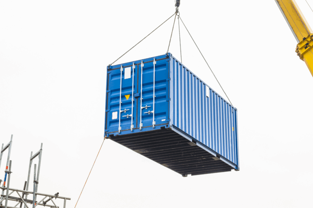 a drayage container being lifted onto a semi truck at a port