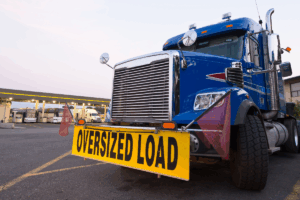 Full truckload carrier hauling an oversized load on a specialized heavy haul trailer.