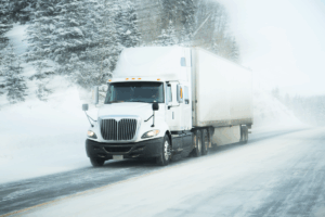 Expedited shipping shown by a truck zooming on a snowy road.