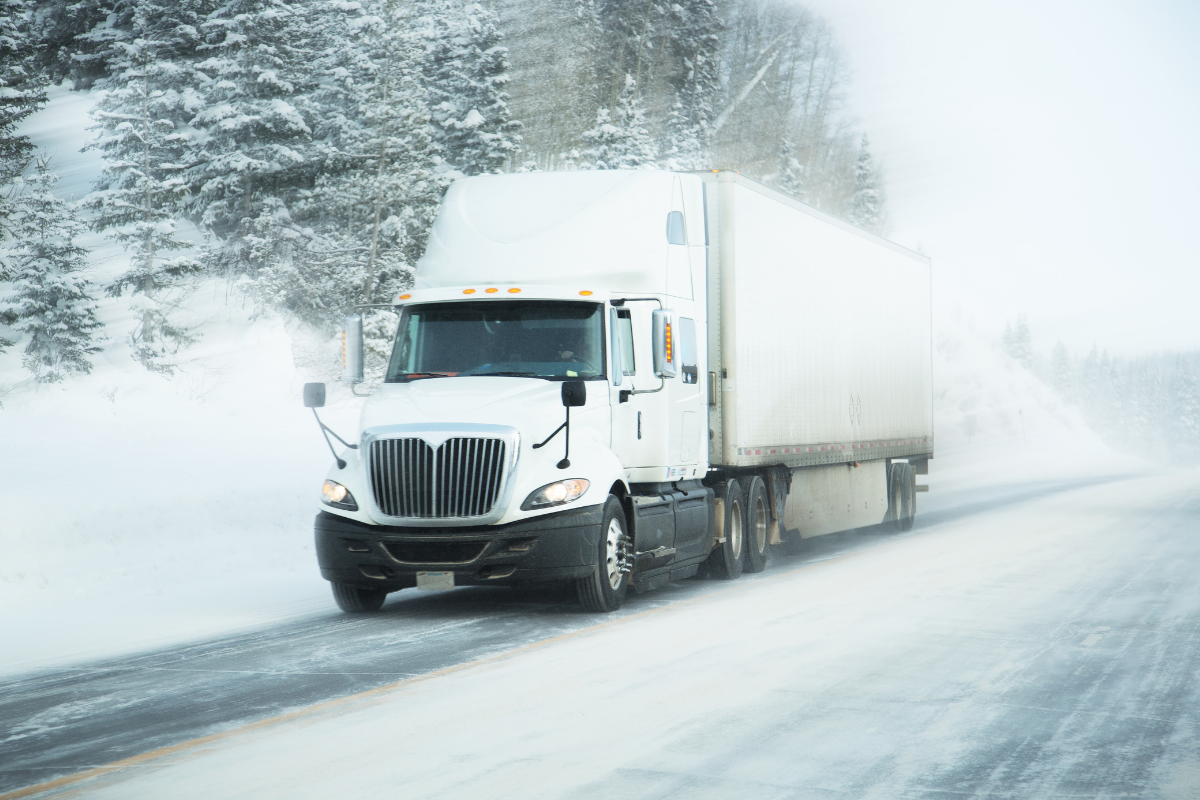 Expedited shipping shown by a truck zooming on a snowy road.