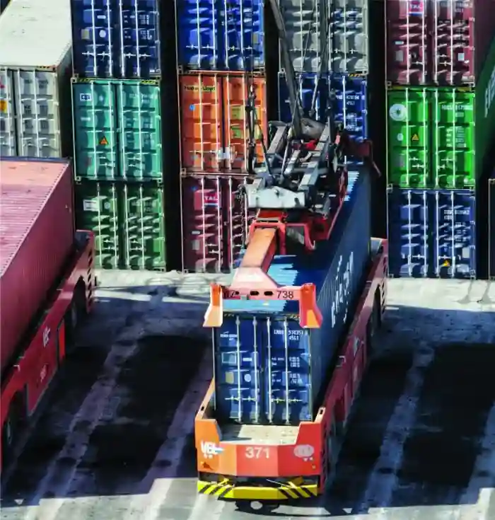 Container ship unloading at a port, representing drayage services