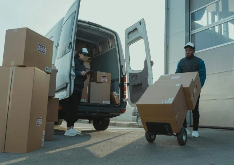 TOP Worldwide expedited freight with a sprinter van being unloaded for urgent and time-sensitive shipments.