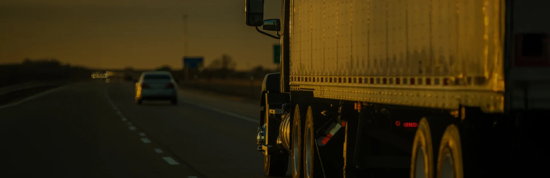 TOP Worldwide Less Than Truckload (LTL) shipping services with a semi truck driving down the highway at sunset, symbolizing efficient and flexible freight solutions.