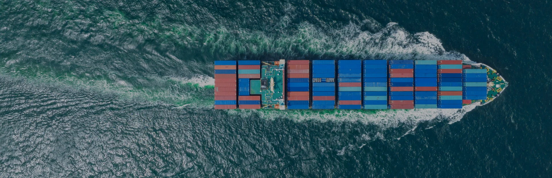 TOP Worldwide ocean freight services with a cargo ship navigating international waters, representing reliable global shipping solutions.